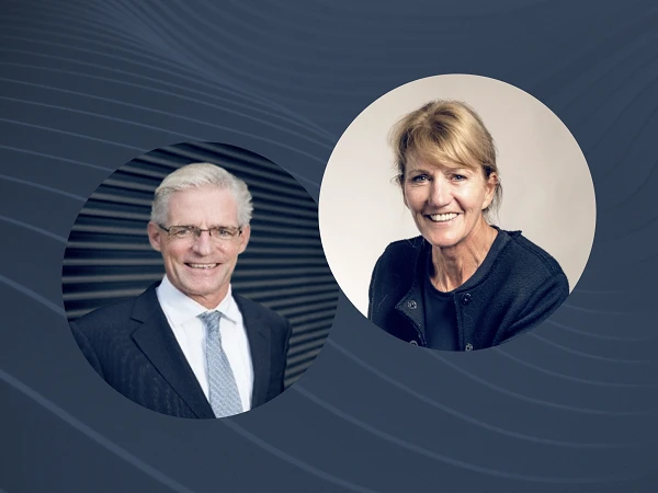 Two professional headshots side by side: a man in a suit with glasses on the left and a woman with blonde hair in a black jacket on the right, both smiling.